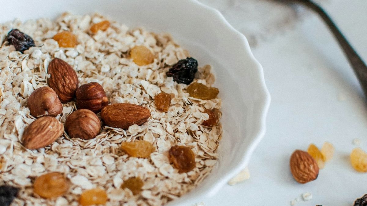 A bowl of oatmeal topped with nuts, a high-fiber whole-grain breakfast