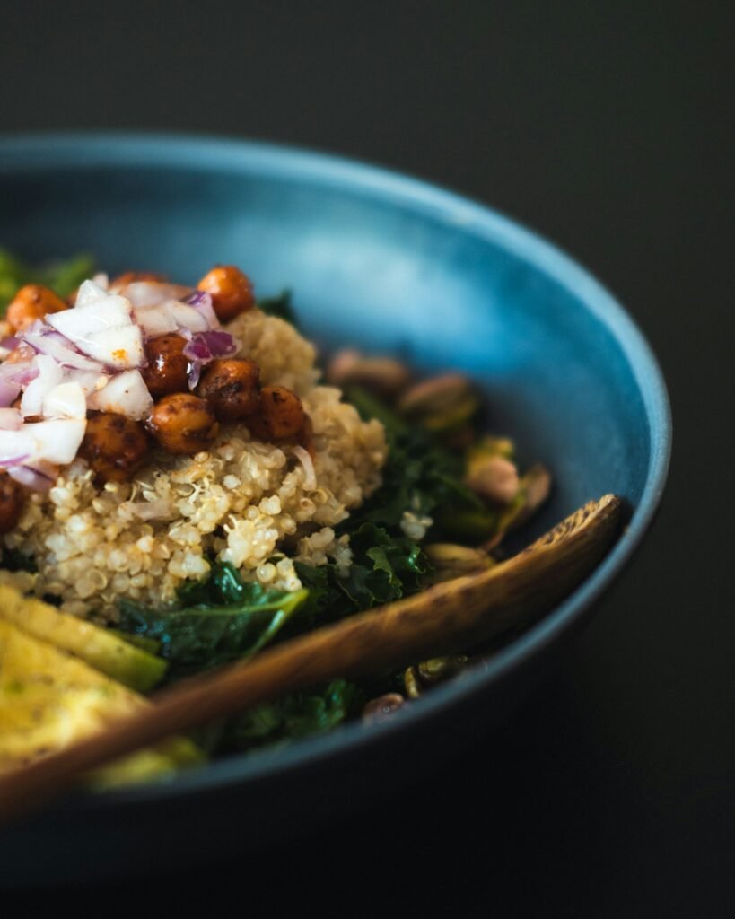 Bowl of quinoa with roasted chickpeas, greens and vegetables