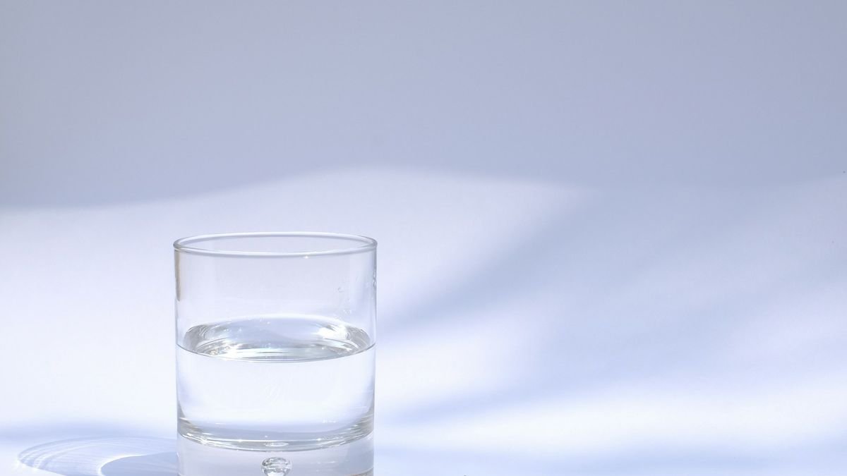 A clear drinking glass filled with water